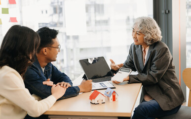 A family couple sign a lease meeting with a realtor or homeowner, purchase the first mortgage and mortgage ownership concept.