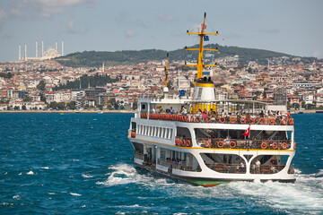 Ferry in Bosphorus strait. Camlica mosque in Istanbul. Turkey