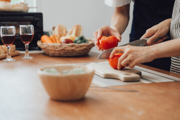 loving husband and wife is cooking dinner in home kitchen