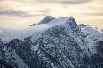 Obraz premium Civetta resort. Panoramic view of the Dolomites mountains in winter, Italy. Ski resort in Dolomites, Italy. Aerial drone view of ski slopes and mountains in dolomites.