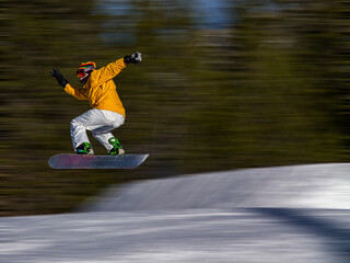 Snowboarder during a trick on a slope