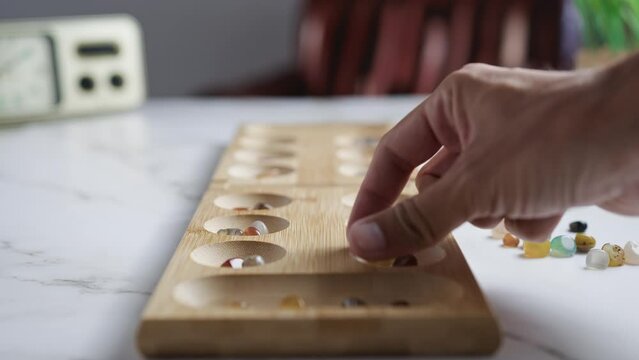 Playing at mancala African game