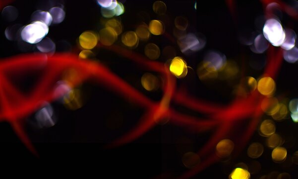Golden blurred colored lights on dark background.
