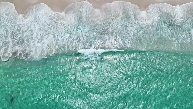 birdseye view looking down on waves white sand 4k
