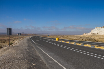 Fototapeta na wymiar A road near the holy place of Man Ata in the Mangystau region, Kazakhstan. Highway Atyrau - Aktau.