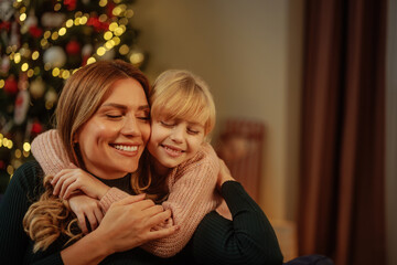Mother and daughter hugging for holidays