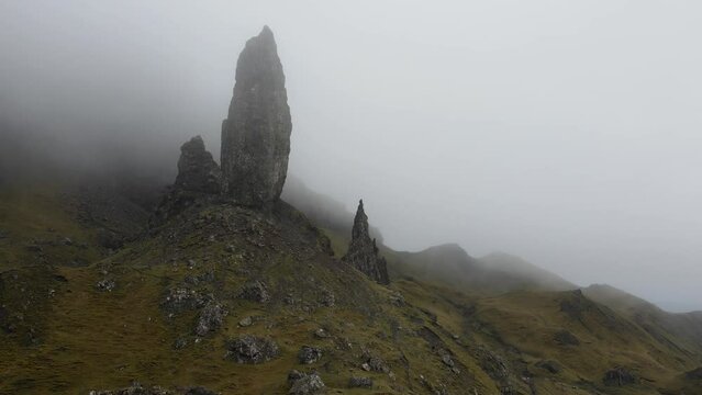 Aerial view of the Old Man Storr. The dramatic and misty environment adds to its mystique and beauty, creating an ethereal atmosphere that captivates visitors and photographers.