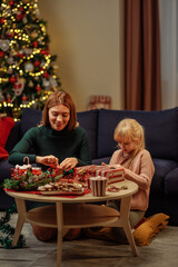 Mother and daughter bonding while packing presents