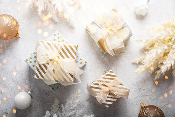 Merry Christmas and Happy Holidays greeting card, frame, banner. New Year. Noel. Christmas gifts on light background top view. Winter xmas holiday theme. Flat lay