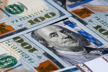 Macro shot of a brand new one hundred dollar bill showing the face of Benjamin Franklin.