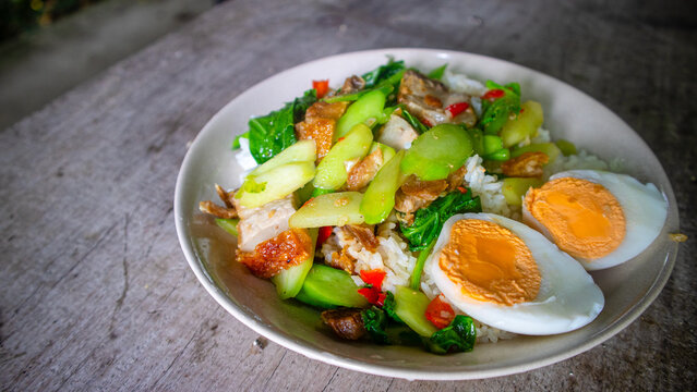 Thai food, kana moo krob.(fried kale mixed crispy pork),Crispy Pork fried with Kale Thai delicious food, closeup, side view