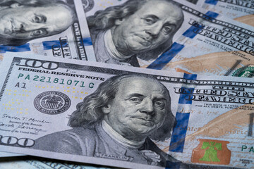 Obraz na płótnie Canvas A pile of one hundred US banknotes. Cash of hundred dollar bills, dollar background image.