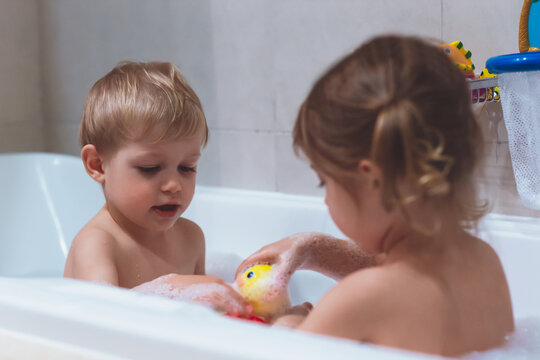 Happy kids taking bubble bath