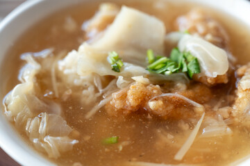 Delicious fried narrow-barred Spanish mackerel fish fillet with rice and noodles in thick soup in Taiwan.