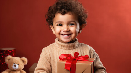 Fototapeta na wymiar little cute boy holding gift box with ribbons on color background, child in knitted sweater, smiling happy kid, new year, christmas, eve, present, kindergarten, childhood, holiday, winter, toddler