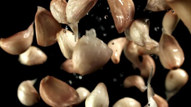 Fresh garlic flies up. View from above. Filmed on a high-speed camera at 1000 fps. High quality FullHD footage