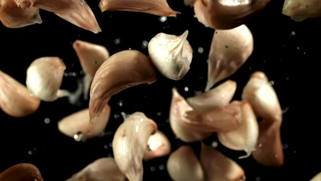 Fresh garlic flies up. View from above. Filmed on a high-speed camera at 1000 fps. High quality FullHD footage