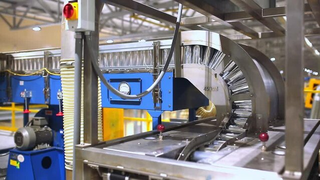 Conveyor line with the production of aluminum cans. Production of aluminum cans for drinks. Plant of high-tech equipment for the food industry.