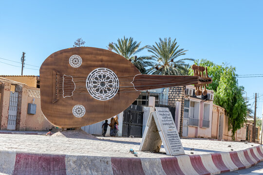 Bechar, Algeria - December 29, 2022: a large memorial monument lute exposed on a roundabout in tribute to the famous musician Abdelaziz Abdallah or Alaa El Foundou in the city town of Bechar.