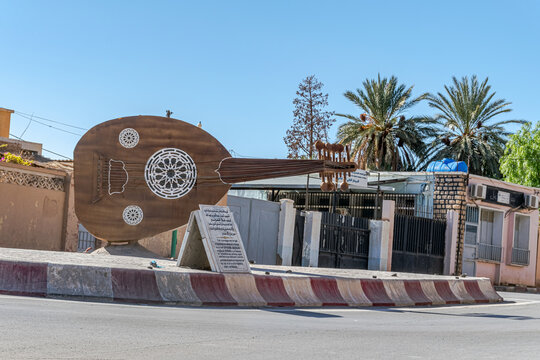 Bechar, Algeria - December 29, 2022: a large memorial monument lute exposed on a roundabout in tribute to the famous musician Abdelaziz Abdallah or Alaa El Foundou in the city town of Bechar.