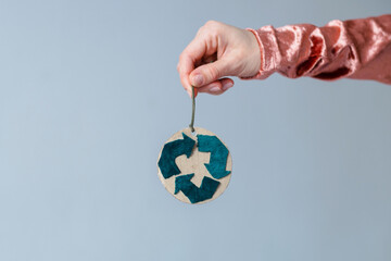 Handmade Christmas decoration in women's hands. Creative symbol of clothing recycling. Ecological and sustainable fashion - obrazy, fototapety, plakaty