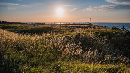 View of Pointe du Hoc in French Normandy at sunset. - obrazy, fototapety, plakaty