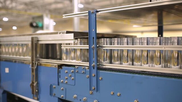 Conveyor line with the production of aluminum cans. Production of aluminum cans for drinks. Plant of high-tech equipment for the food industry.