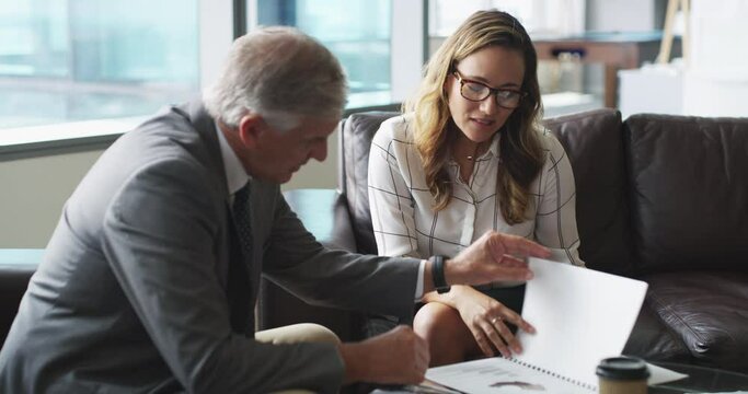 Business people, documents and meeting in lobby for advice, contract information and planning of loan or budget proposal. Senior boss, financial advisor or clients reading portfolio and consulting