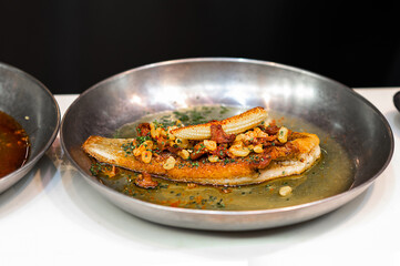Street food dish, fried fish fillet with vegetables on the table, fast food meal.
