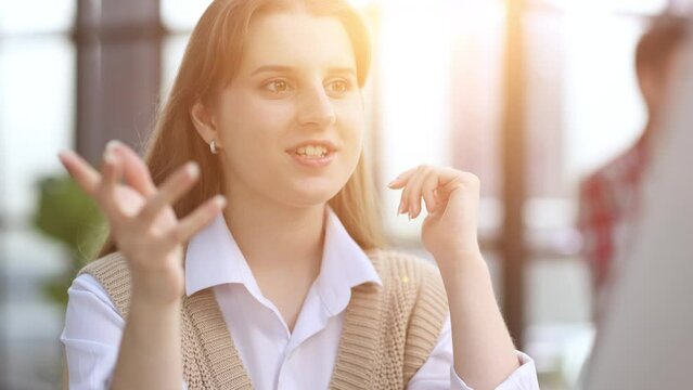 The girl looks thoughtfully at the laptop monitor. Online work. Distance learning. Freelancer works in a ofice.