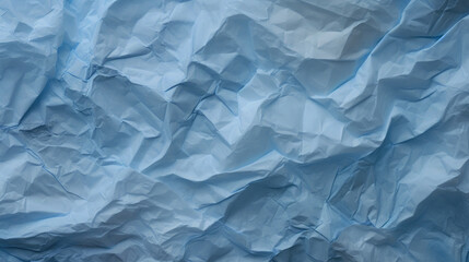 Crumpled, wrinkled, blue, thin, blank paper as background and texture with rough surface