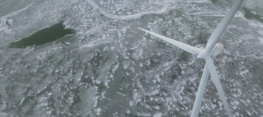 A wind turbine standing in a frozen sea among ice floes. The concept of renewable energy sources, in particular wind energy, and its ability to function in extreme conditions. 3D Illustration.