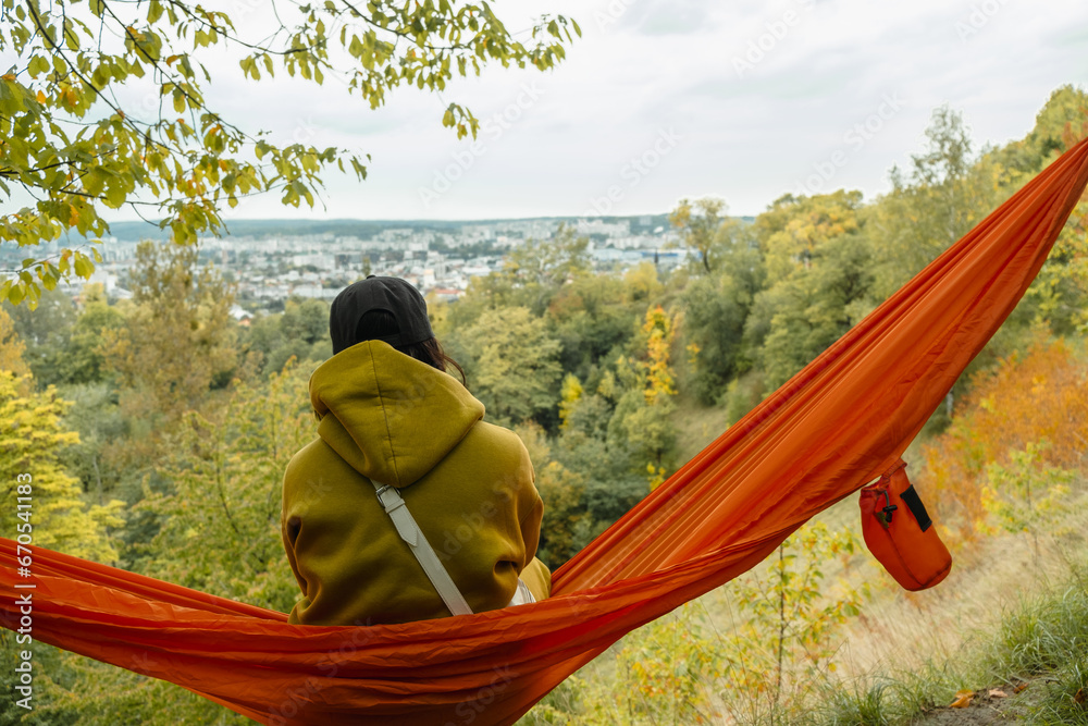 Canvas Prints woman view from behind sitting on the hammock enjoying view