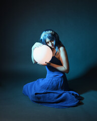 Full length portrait of beautiful female model wit blue hair wearing glamorous  fantasy ball gown...