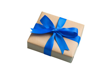 Wrapped christmas or other holiday handmade present in craft paper with colored ribbon. Present box, decoration of gift on table, top view with copy space