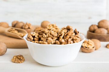 Fresh healthy walnuts in bowl on colored table background. Top view Healthy eating bertholletia concept. Super foods