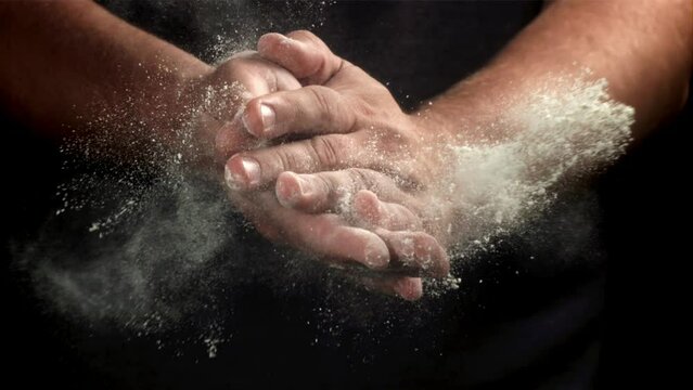 The cook claps his hands with flour. Filmed on a high-speed camera at 1000 fps. High quality FullHD footage
