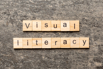 visual literacy word written on wood block. visual literacy text on cement table for your desing,...