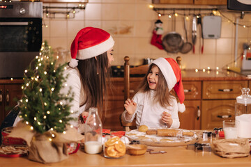 Making gingerbread at home. Little girl cutting cookies of gingerbread dough. Christmas and New Year traditions concept. Christmas bakery. Happy holidays