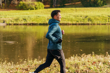 Trainer runner in warm sportswear winter training.  The athlete is active and healthy in winter in...