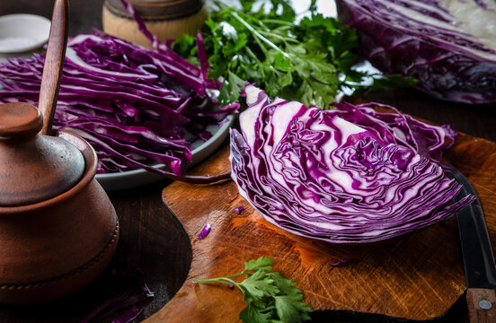 Chopped red cabbage close-up on a cutting wooden board in the kitchen
