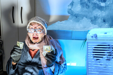 Man feeling cold at home with home heating trouble  counts money for electricity and heating bills
