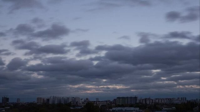 Time lapse of clouds in the sky from day to night.