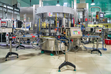 Cooking oil or Sunflower oil in the bottle moving on production line, factory in Ho Chi Minh city, Vietnam - obrazy, fototapety, plakaty
