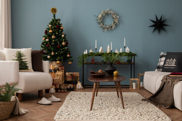 Amazing and cozy christmas living room interior with modular sofa, boucle armchair, wooden consola, candlestick, christmas tree, gifts, decoration and elegant accessories. Family time. Template.