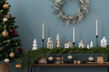 Aesthetic composition of christmas living room interior with wooden console, spruce, white candles,...