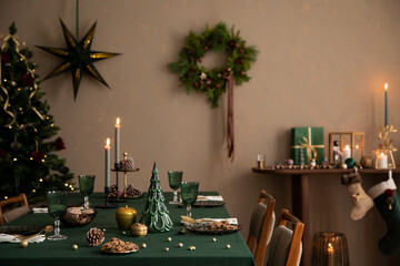 Interior design of warm dinning room interior with christmas table, wooden console, christmas...