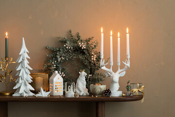 Elegant composition of christmas living room interior with wooden console, stylish wreath, deer...