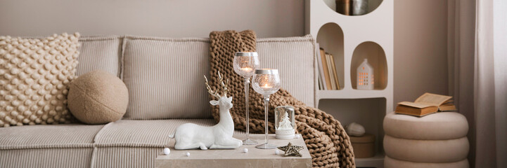 Amazing composition on white design shelf with christmas decoration, lights, gifts, lanterns, deer,...