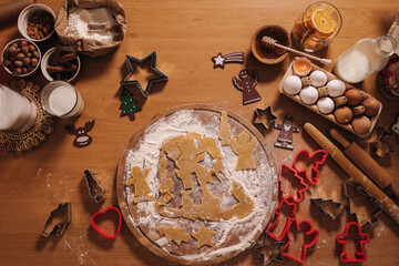 Home bakery, cooking traditional festive sweets. Preparing for making gingerbread dough on wooden table. New Year celebration traditions. Honey and dried orange wedges. Christmas mood. Top view 